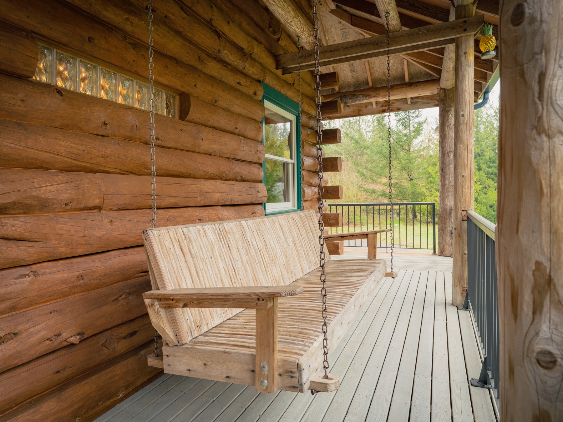 Covered porch swing and forest view at Blue Roof Lodge
