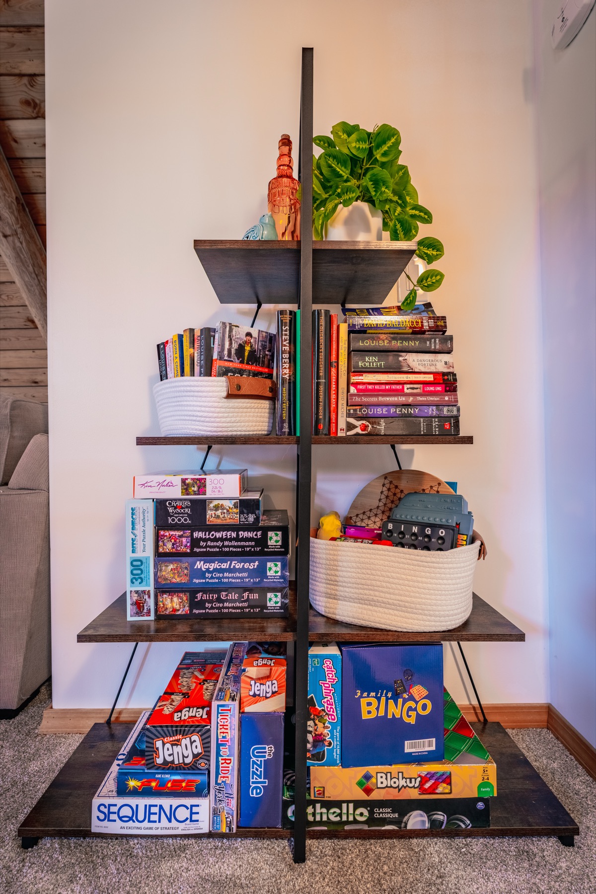 Shelf filled with books, puzzles, and family games